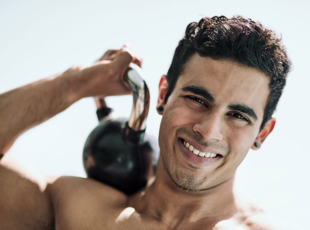 Man holding weights on his shoulder.