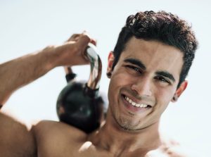 Man holding weights on his shoulder.